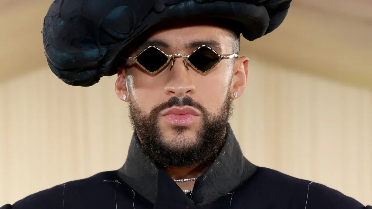 Bad Bunny at the Met Gala, sporting diamond-shaped sunglasses and a dramatic black hat.