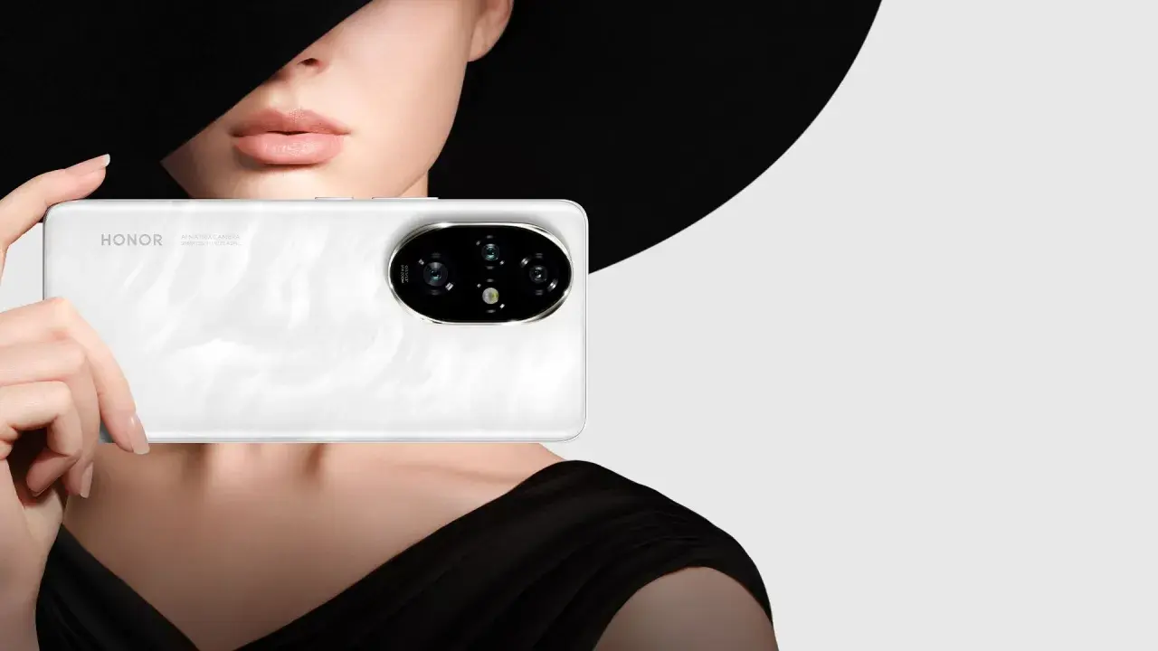 Primo piano di un telefono Honor bianco con un'elegante donna sullo sfondo, che evoca un effetto ritratto foto.