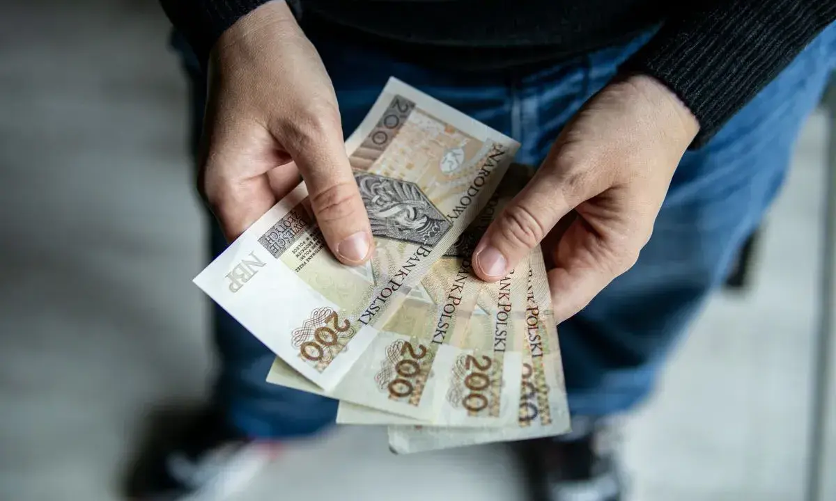 Dłonie trzymają banknoty 200 zł. Czy to odpowiedź na pytanie: 800 plus dla kogo?