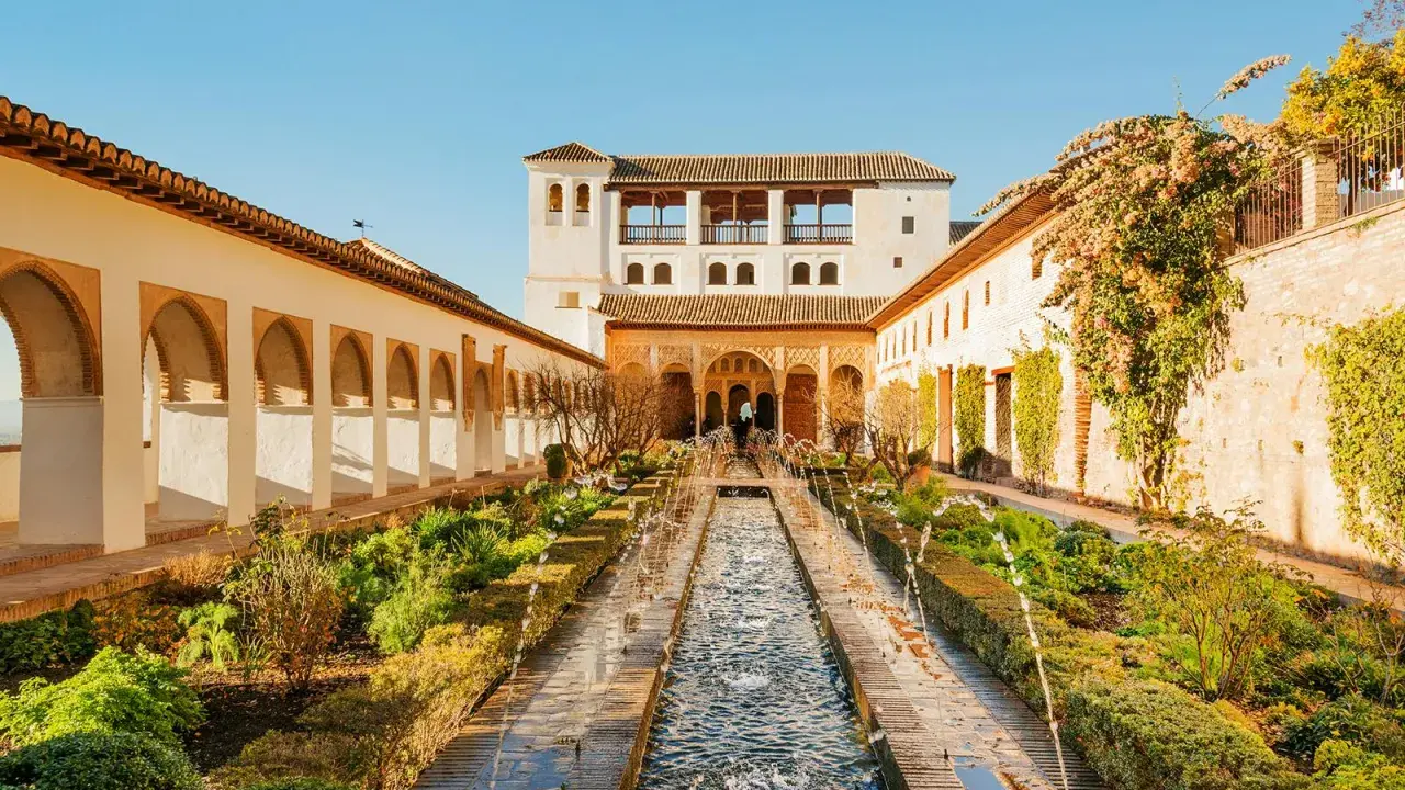 Der Patio de la Acequia im Generalife der Alhambra mit Wasserspielen und Arkaden.