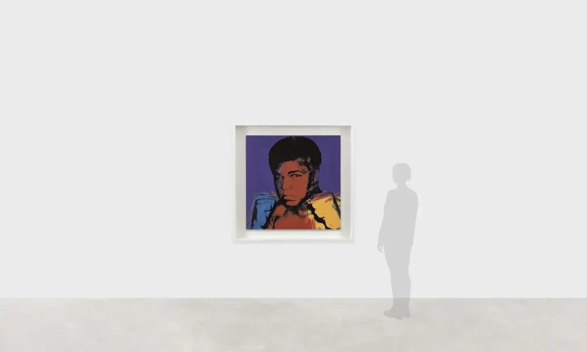 Andy Warhol's iconic portrait of Muhammad Ali, rendered in bold colors, captures the boxer's powerful stance.