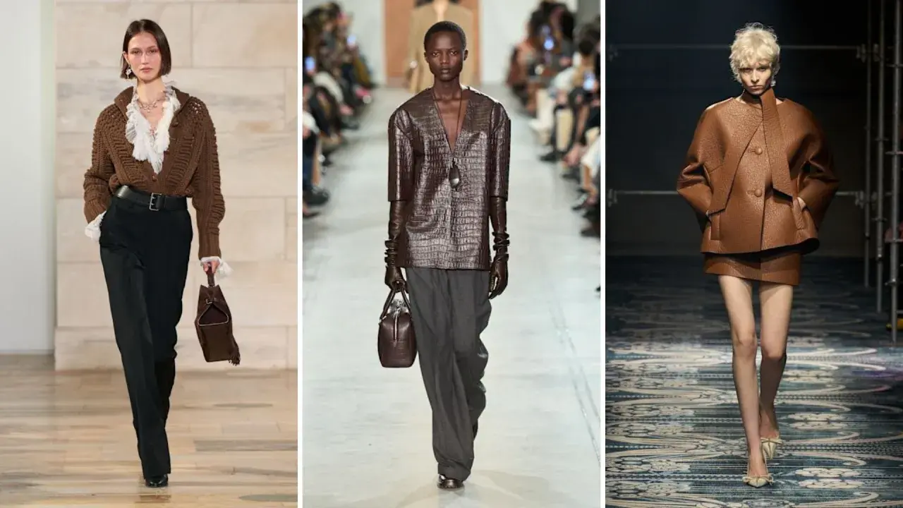Modelli sfilano con outfit in colore testa di moro, mostrando abbinamenti eleganti con pantaloni neri, grigi e completi in pelle.