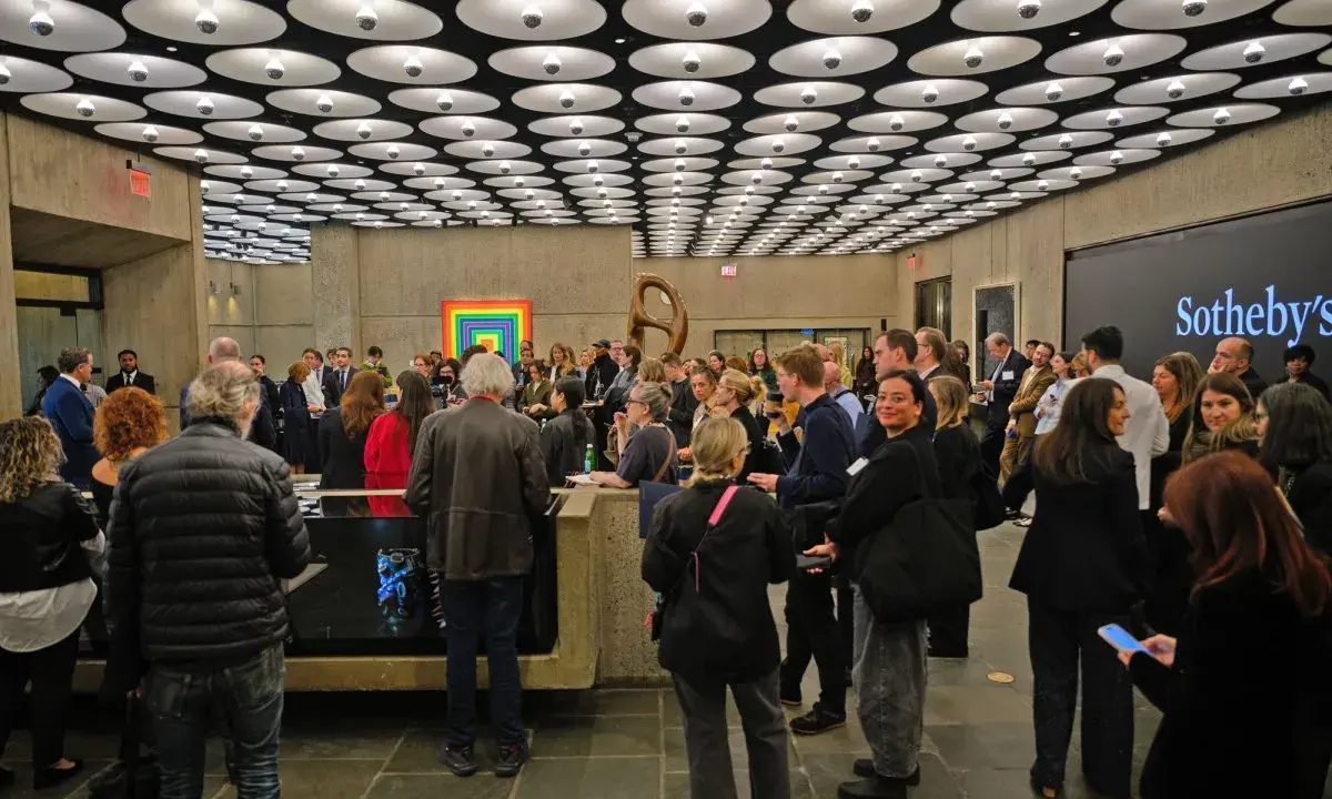 A crowd gathers at a Sotheby's event, a vibrant scene in the contemporary art market.