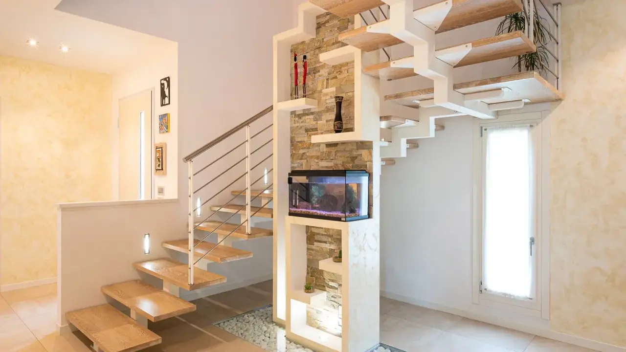 Moderna scala interna in legno e metallo con acquario integrato. Il design innovativo suggerisce un interessante costo scala interna.