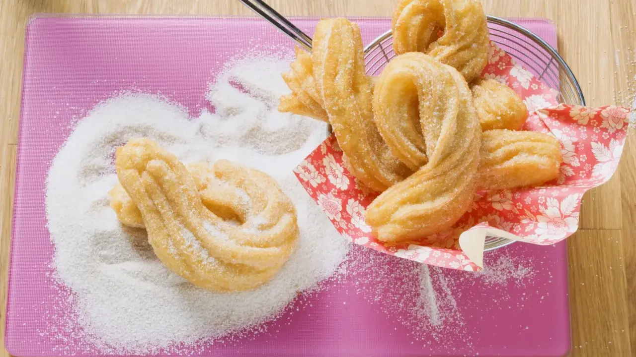 Churros dorés saupoudrés de sucre, prêts à être dégustés. Une délicieuse recette churros pour le plaisir des gourmands.