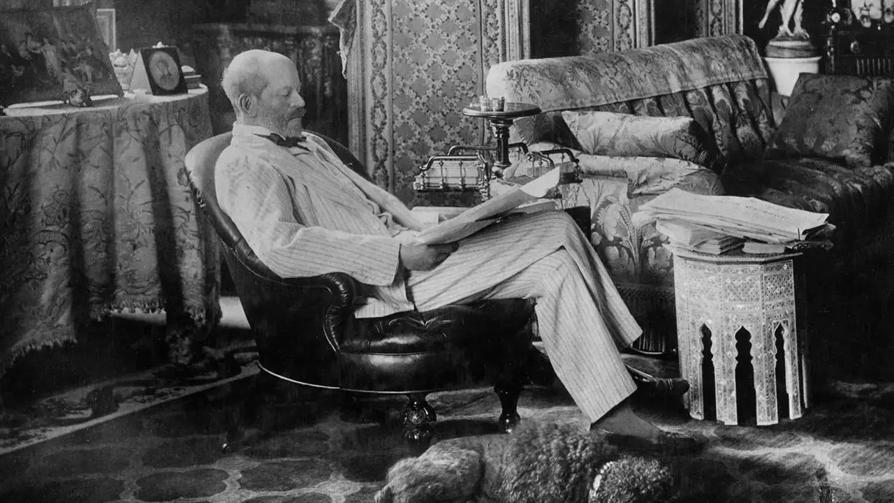 A man reads in a plush armchair, a dog sleeps nearby. The opulent room hints at the grandeur of the Rothschild art collection.