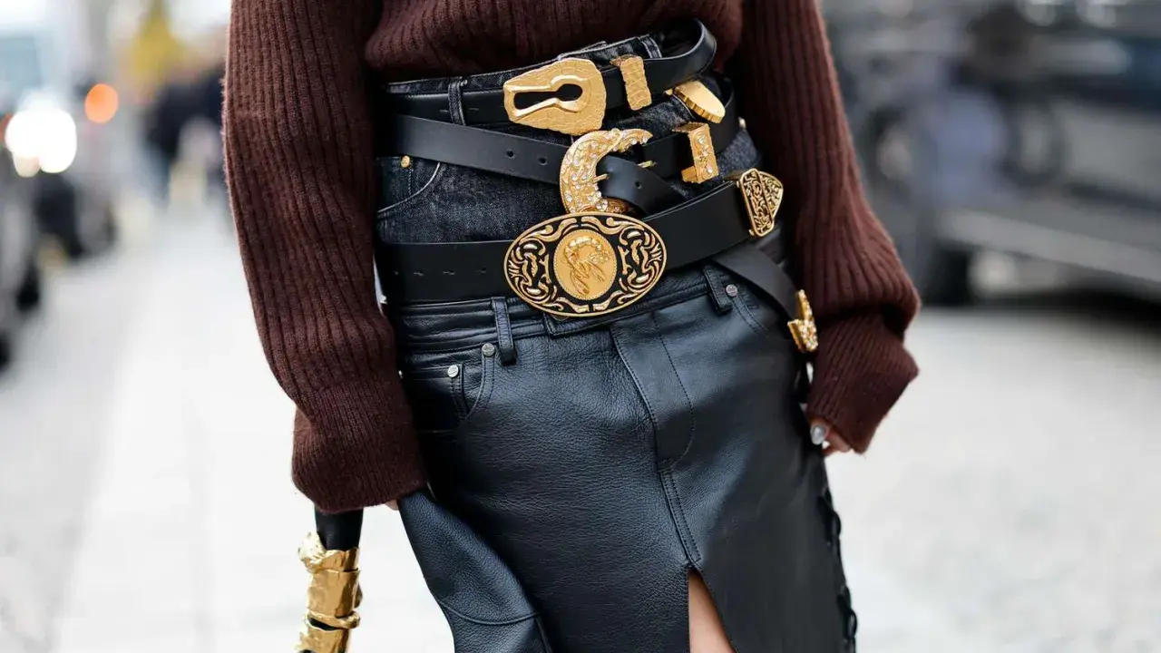Layered black belts with ornate gold buckles make a bold statement, proving belts are definitely in style.