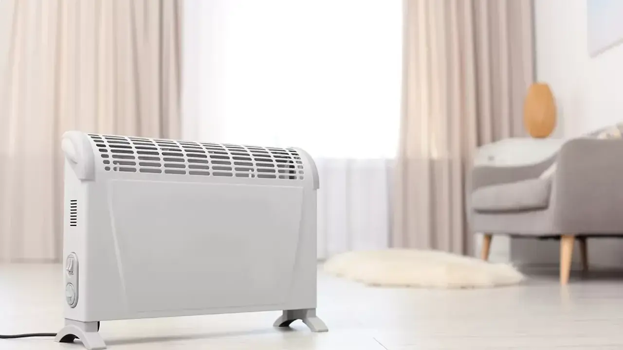 Ein weißer Elektroheizer steht im Wohnzimmer. Er hilft, die strom heizung kosten pro monat im Blick zu behalten.