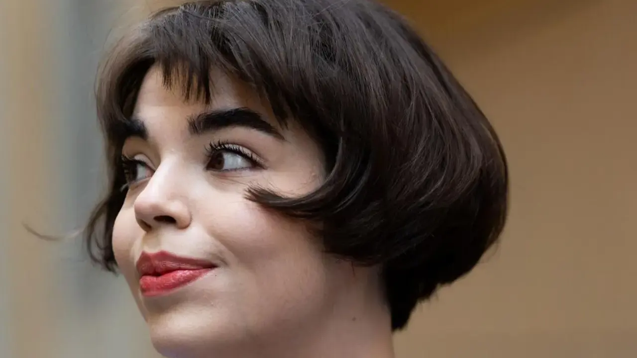 Ein kurzer Bob mit leichten Wellen, der ihr Gesicht umrahmt. Perfekt gestylt für einen mühelosen Look.