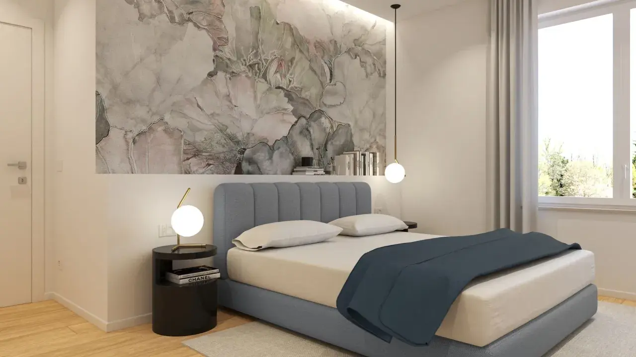 Idee per cosa mettere su un comò in camera da letto: un tavolino nero con lampada, libri e un vaso con fiori secchi.