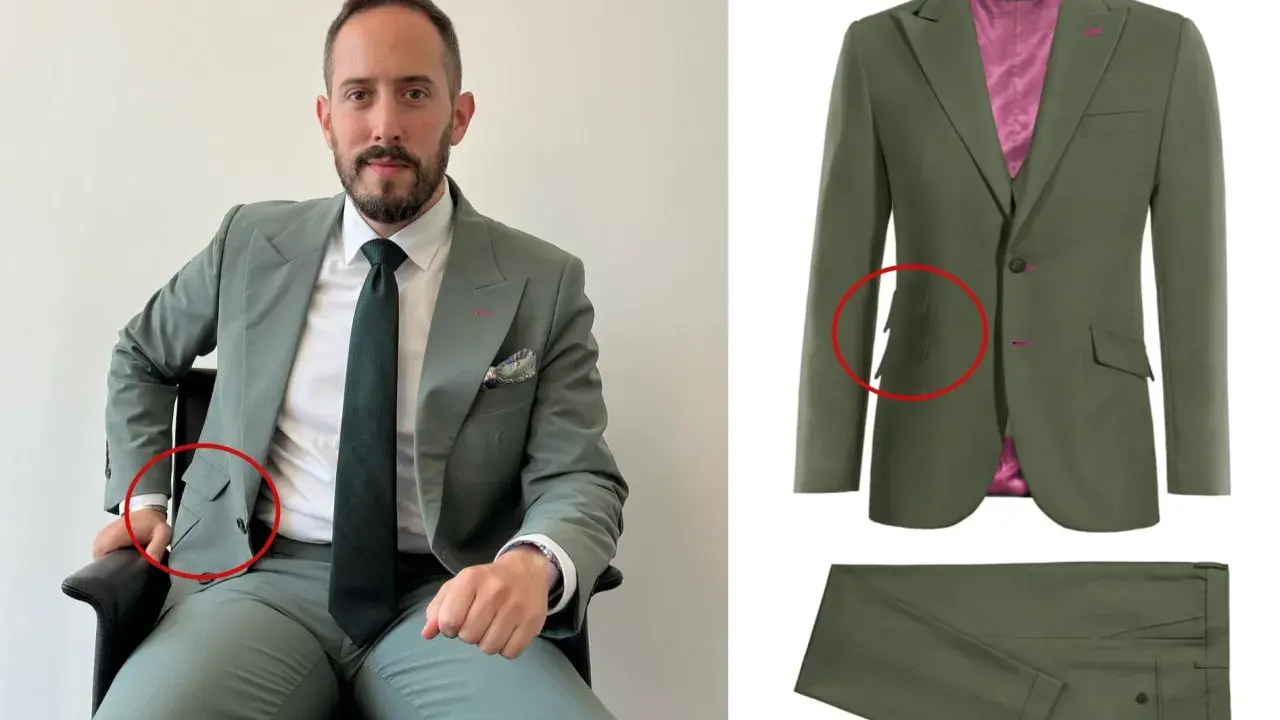 Man in a sage green suit with a ticket pocket, showing off the suit's details.