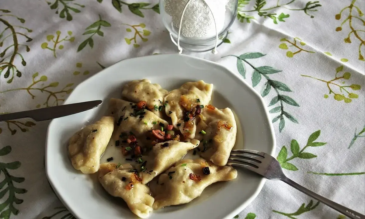 Pyszne pierogi z boczkiem i cebulką, idealne z kwaśną śmietaną. Z czym podawać pierogi? Zawsze z apetytem!