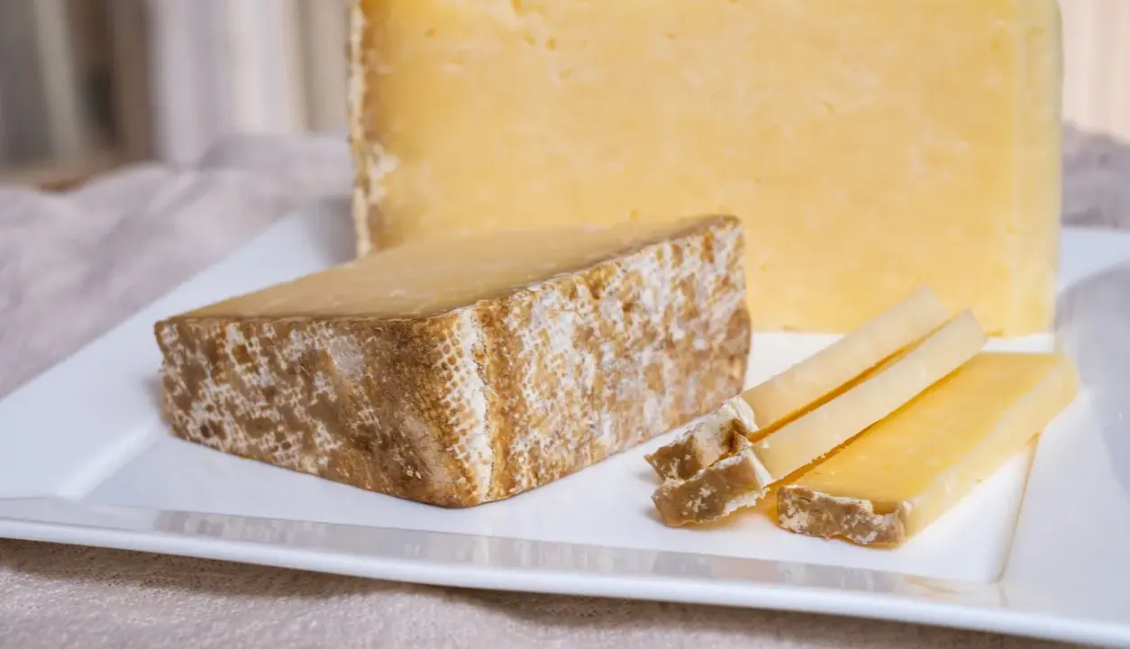 Tranches de Cantal, une des spécialités du Cantal, sur une assiette blanche.