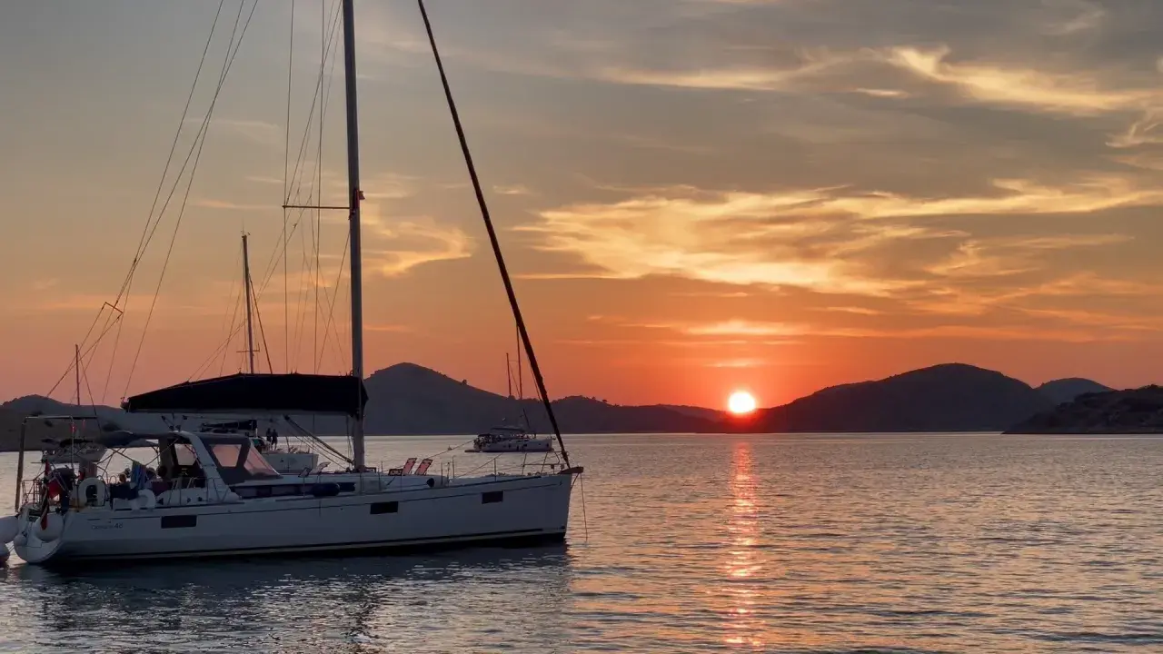 Voiliers au coucher du soleil, une scène paisible pour apprendre comment mouiller rapidement.