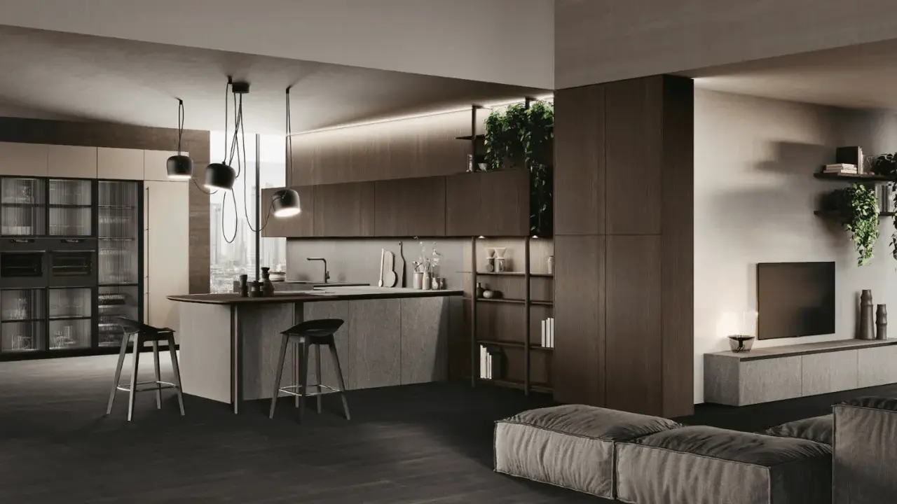 Cuisine en U ouverte sur salon, avec îlot central, tabourets et rangements intégrés. Ambiance moderne et épurée.