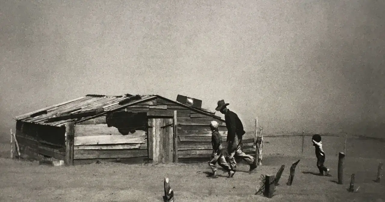 Dust Bowl migrants walk past a dilapidated shack in this iconic Arthur Rothstein photo, a stark reminder of hardship.