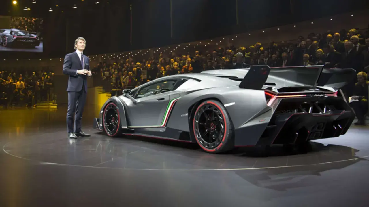 Ein Mann präsentiert den Lamborghini Veneno. Der Lamborghini Veneno Preis ist astronomisch, aber die Exklusivität rechtfertigt ihn.