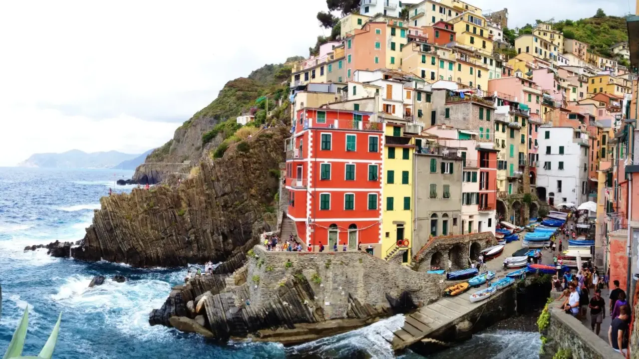 Case colorate aggrappate alla scogliera, barche blu nel porticciolo. Ecco dove si trovano le Cinque Terre, un incanto ligure.