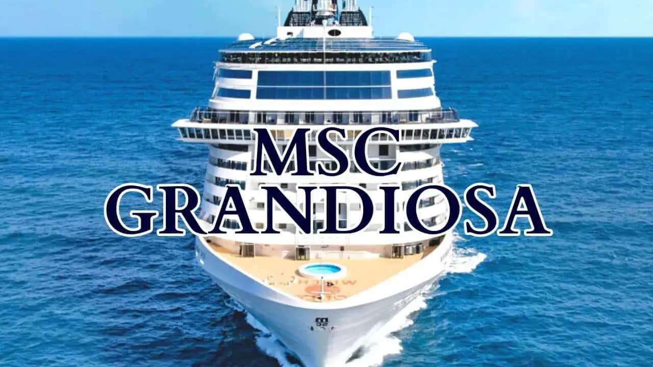 La MSC Grandiosa solca il mare blu, un gigante bianco con ponti che promettono avventure.