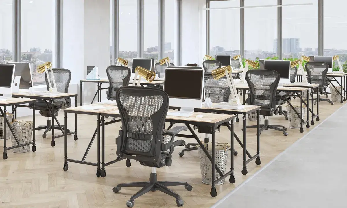 Bureau moderne avec postes de travail alignés, illustrant l'avantage open space pour la collaboration et la flexibilité.