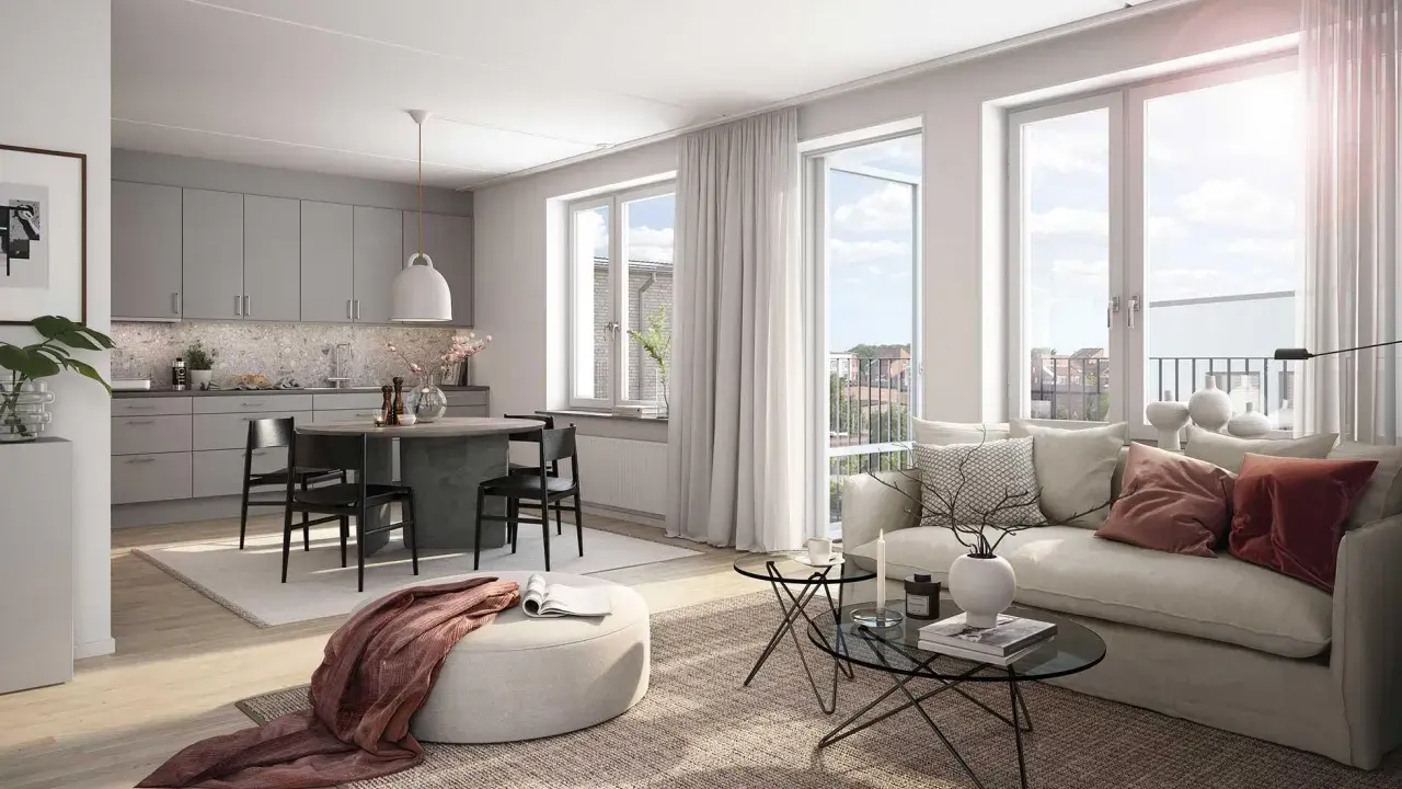 A bright, modern living room and kitchen with a dining table, sofa, and large windows.