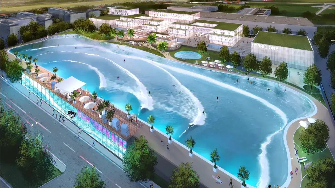 Surfer genießen die künstliche welle in Hallbergmoos. Moderne Gebäude und eine belebte Promenade säumen das Surfbecken.