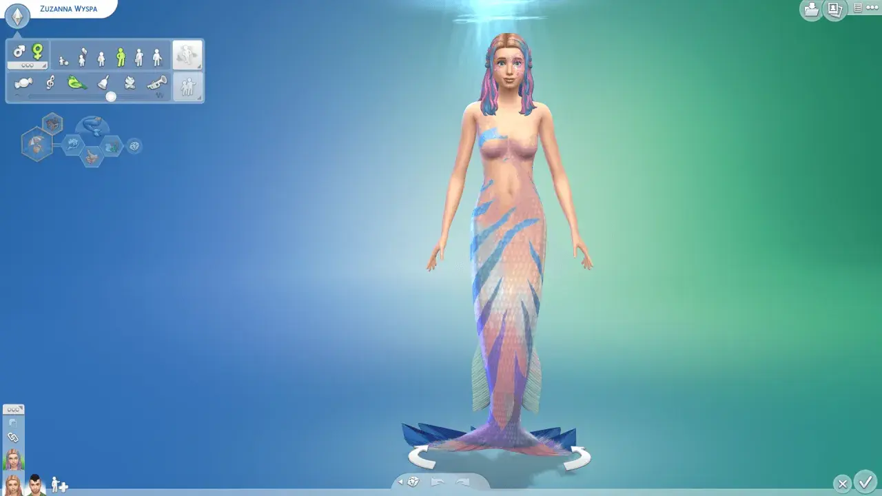 Symulacja Sims 4: Zuzanna Wyspa, piękna syrena z kolorowymi włosami i łuskami, gotowa do zanurzenia się w morskich przygodach.