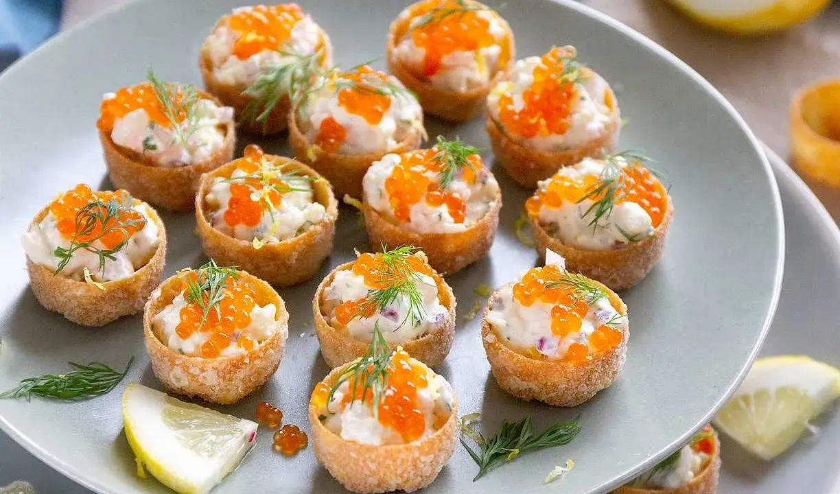 Små, krispiga krustader fyllda med en krämig röra och toppade med orange rom och dill. Perfekt för mingel!