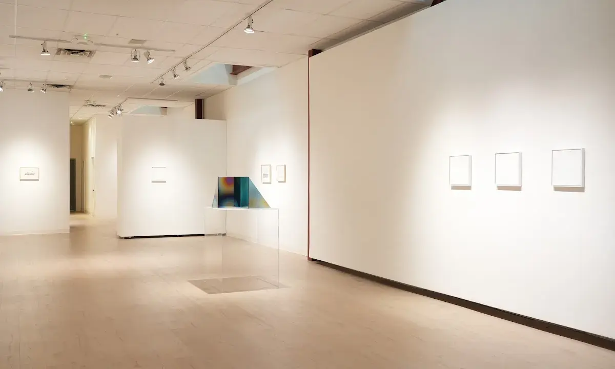 Inside the Richard Levy Gallery, minimalist artworks are displayed on white walls with polished wooden floors.