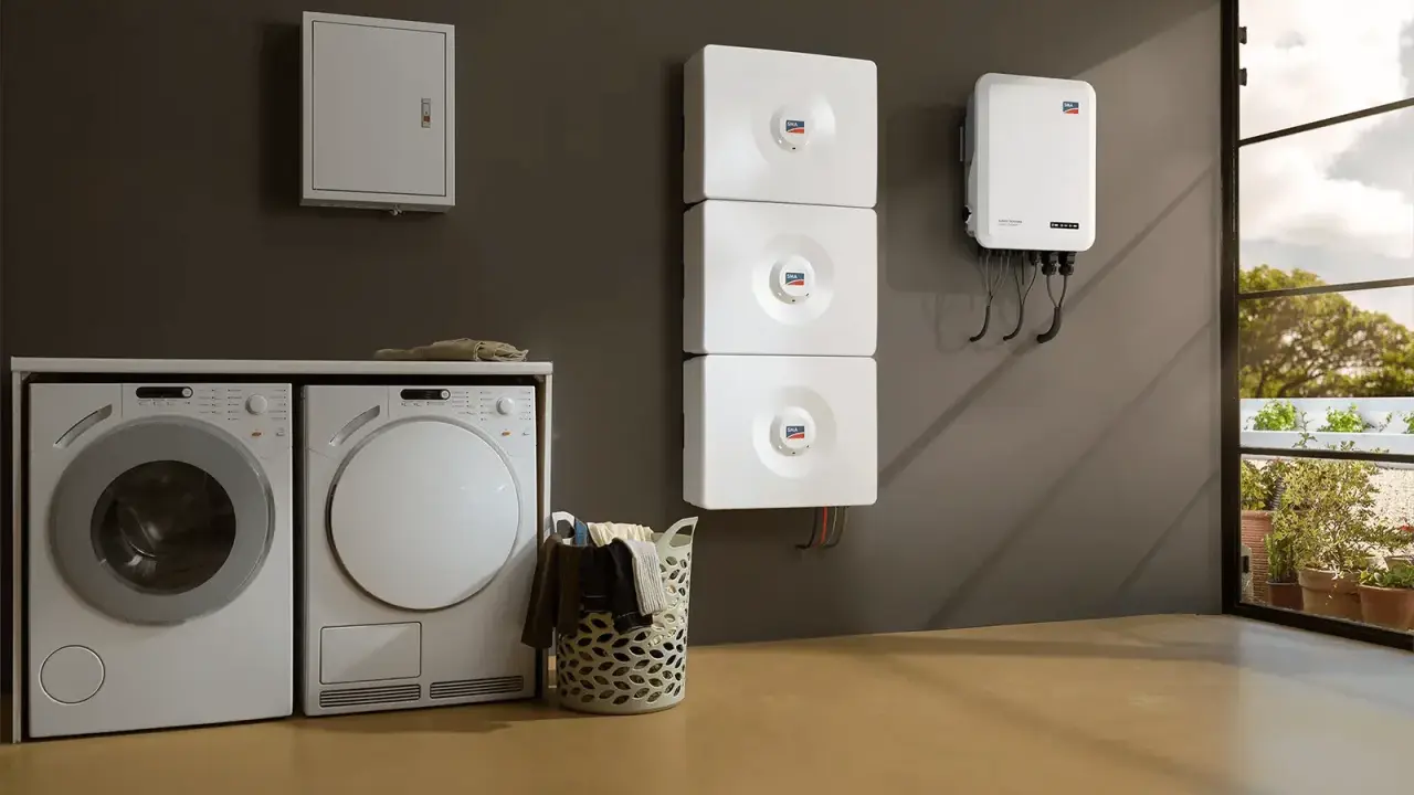Lave-linge et sèche-linge à côté d'un système de stockage d'énergie solaire, prêt pour un séchage écologique.