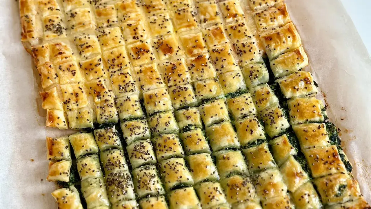 Torta salata con pasta sfoglia, ripiena di spinaci e cosparsa di semi di chia. Un'idea gustosa su cosa mettere dentro la pasta sfoglia.