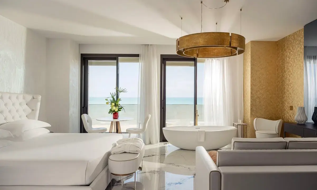 Lussuosa camera con vista mare, perfetta per un soggiorno in un b&b Riviera Romagnola. Letto king, vasca freestanding e arredi eleganti.