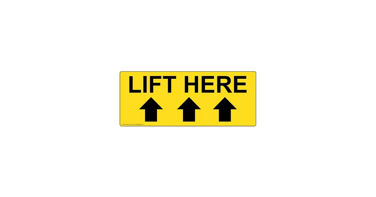 Żółty znak z napisem "LIFT HERE" i trzema czarnymi strzałkami skierowanymi w górę. To jasny znak tu chwytać, by podnieść przedmiot.