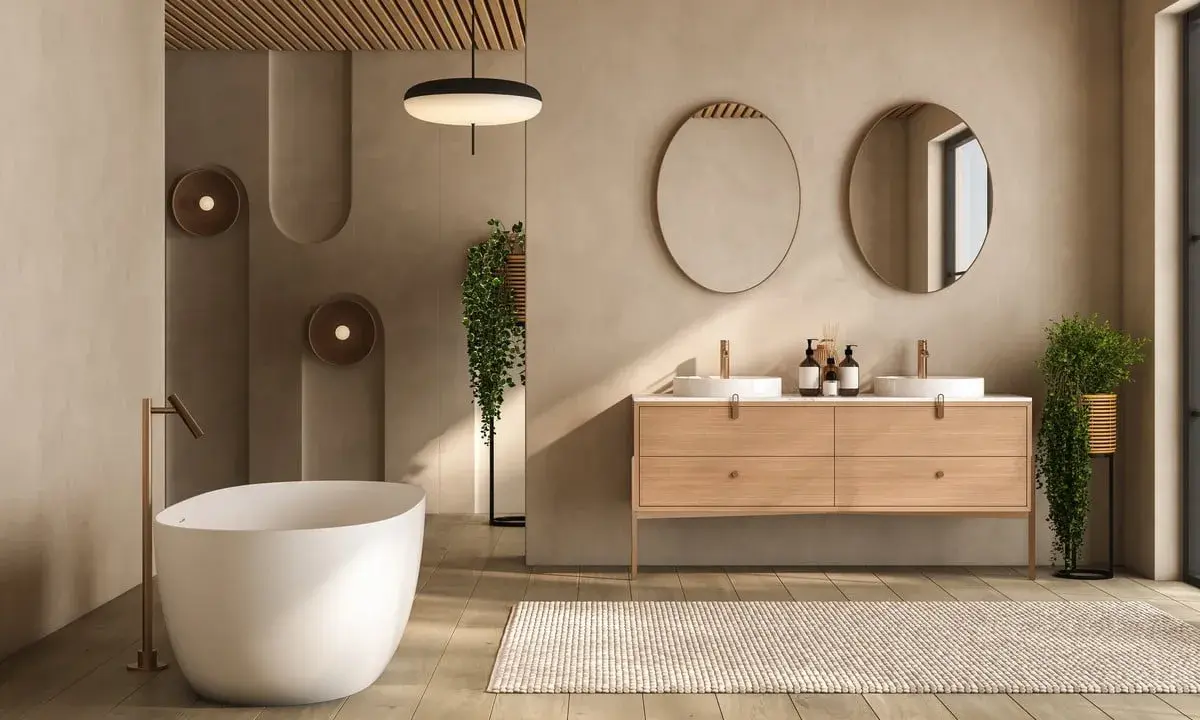 Salle de bain épurée avec baignoire îlot, double vasque et tapis. Le beige et le bois créent une ambiance zen, une couleur à éviter dans une salle de bain serait le noir intense.