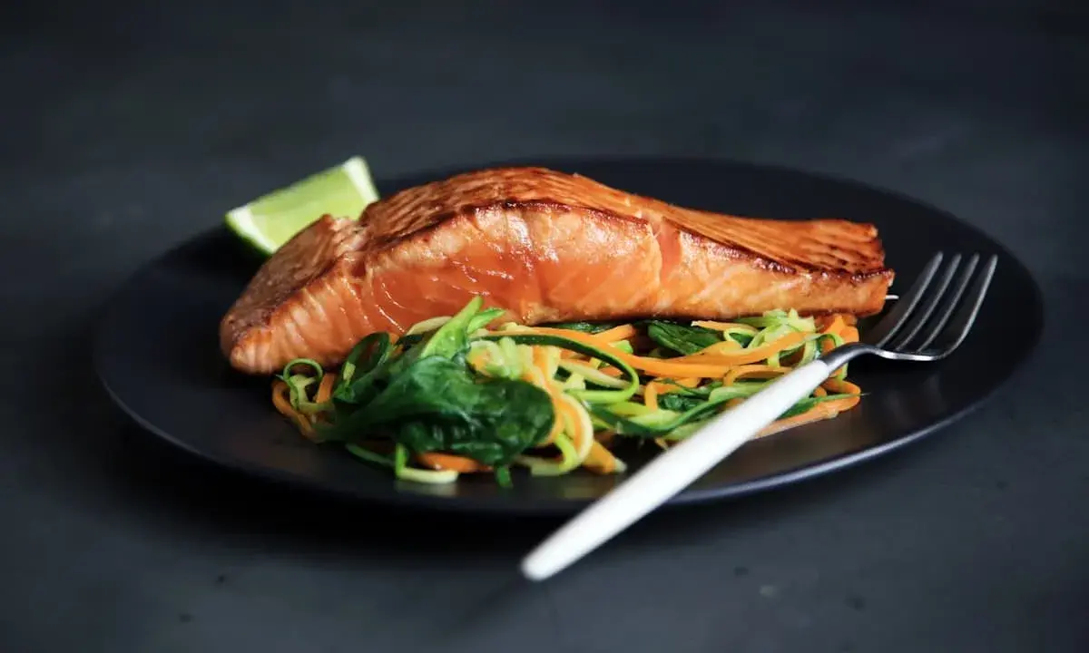 Salmone succulento su letto di verdure miste, un piatto da provare nelle migliori rimini restauracje.