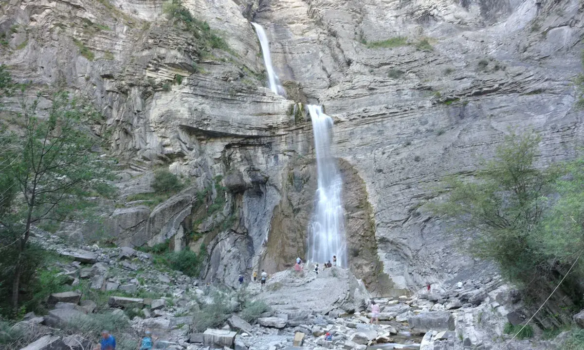 Cascada espectacular, ideal para saber qué hacer en Broto con niños. Familias disfrutan del paisaje rocoso y el agua.