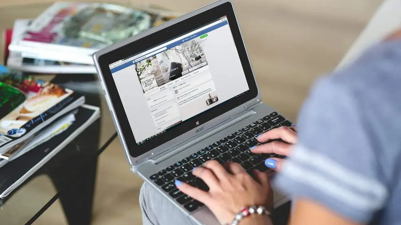 Kobieta pisze na laptopie, przeglądając stronę z inspiracjami wnętrzarskimi. To świetny post powitalny przykład dla nowych użytkowników.
