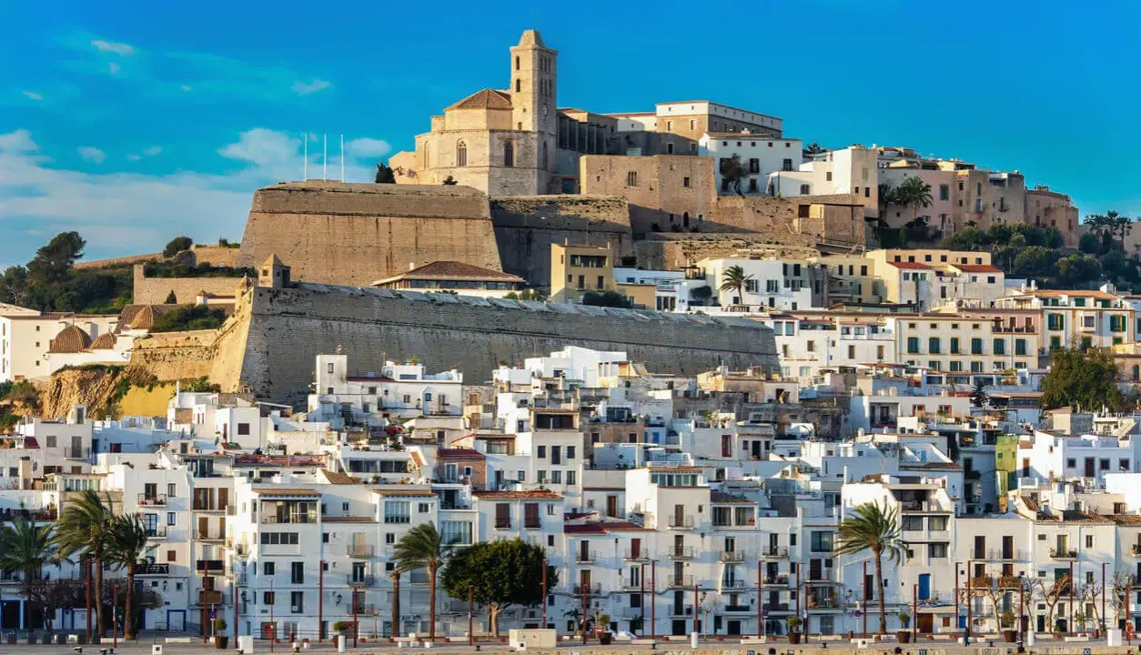 Ibiza pogoda idealna na zwiedzanie Dalt Vila. Białe domy, błękitne niebo i morze tworzą malowniczy widok.