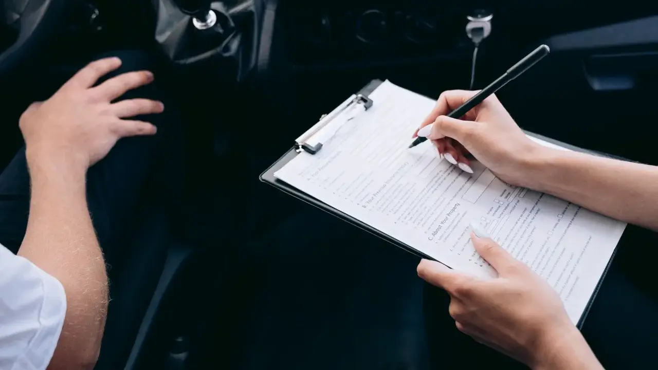 Kobieta wypełnia formularz podczas rejestracji samochodu przez dealera.