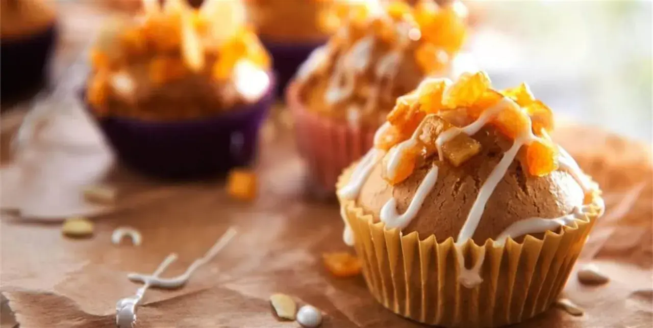 Słodkie muffinki i babeczki, udekorowane lukrem i kandyzowanymi owocami, kuszą swoim wyglądem.
