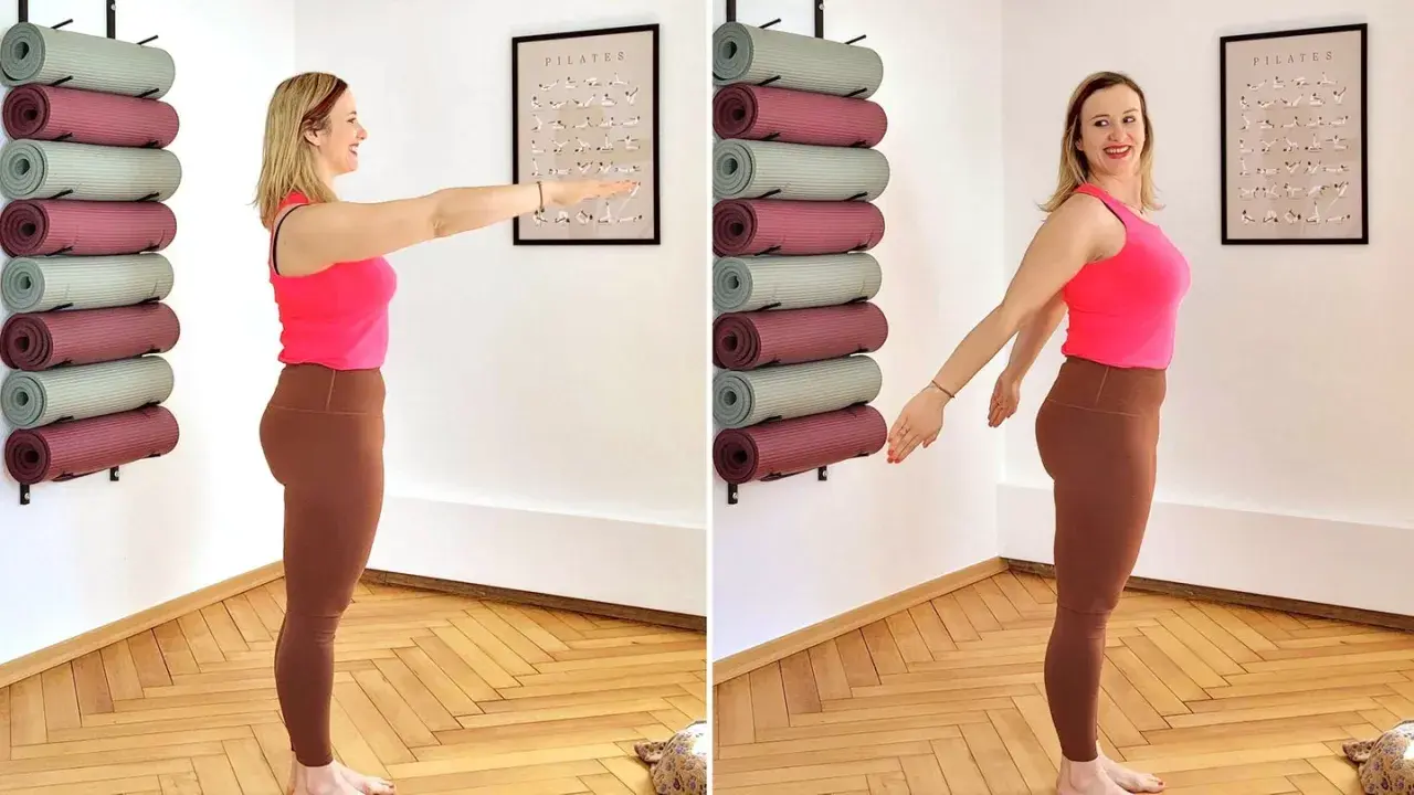 Frau übt tiefe Atmung zur Beruhigung, um sich auf Pilates vorzubereiten. Yogamatten sind an der Wand aufbewahrt.