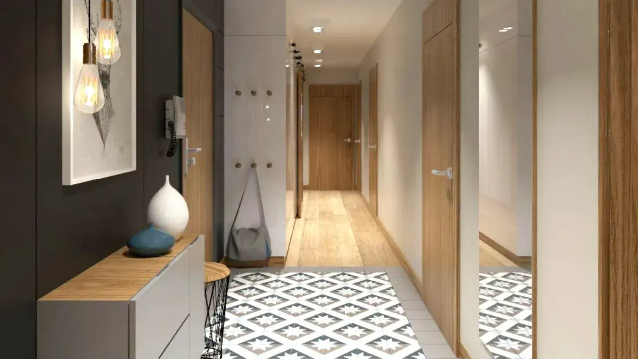 Un corridoio stretto con idee di design moderne: tappeto geometrico, mobili minimalisti, luci a sospensione e specchio a tutta altezza.