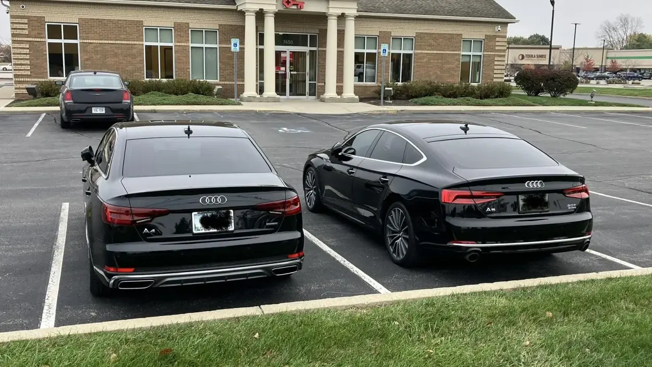 Dos Audis negros, un A4 y un A5, aparcados uno al lado del otro.