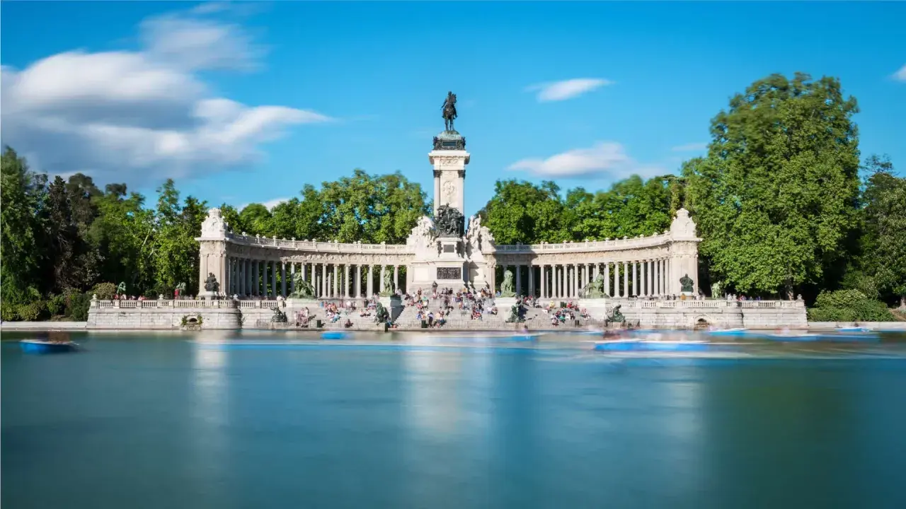 Denkmal für Alfonso XII im Retiro-Park, Spanien Madrid. Boote gleiten über den See vor der beeindruckenden Säulenhalle.
