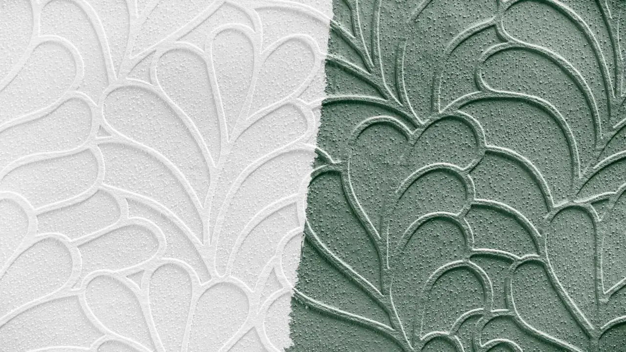 Papier peint en relief, moitié blanc, moitié vert, avec un motif de feuilles stylisées. Idéal pour peindre sur papier peint relief.
