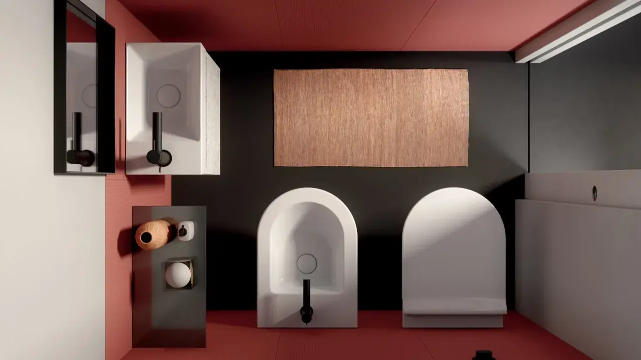 Bagno moderno con wc e bidet di fronte, tappeto in juta e lavabo squadrato.