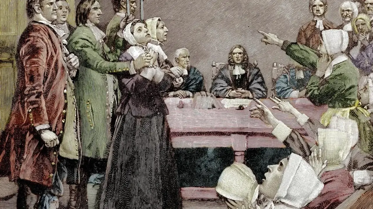 Szene eines Prozesses, der den Puritanismus widerspiegelt. Eine Frau wird beschuldigt, während andere auf sie zeigen.