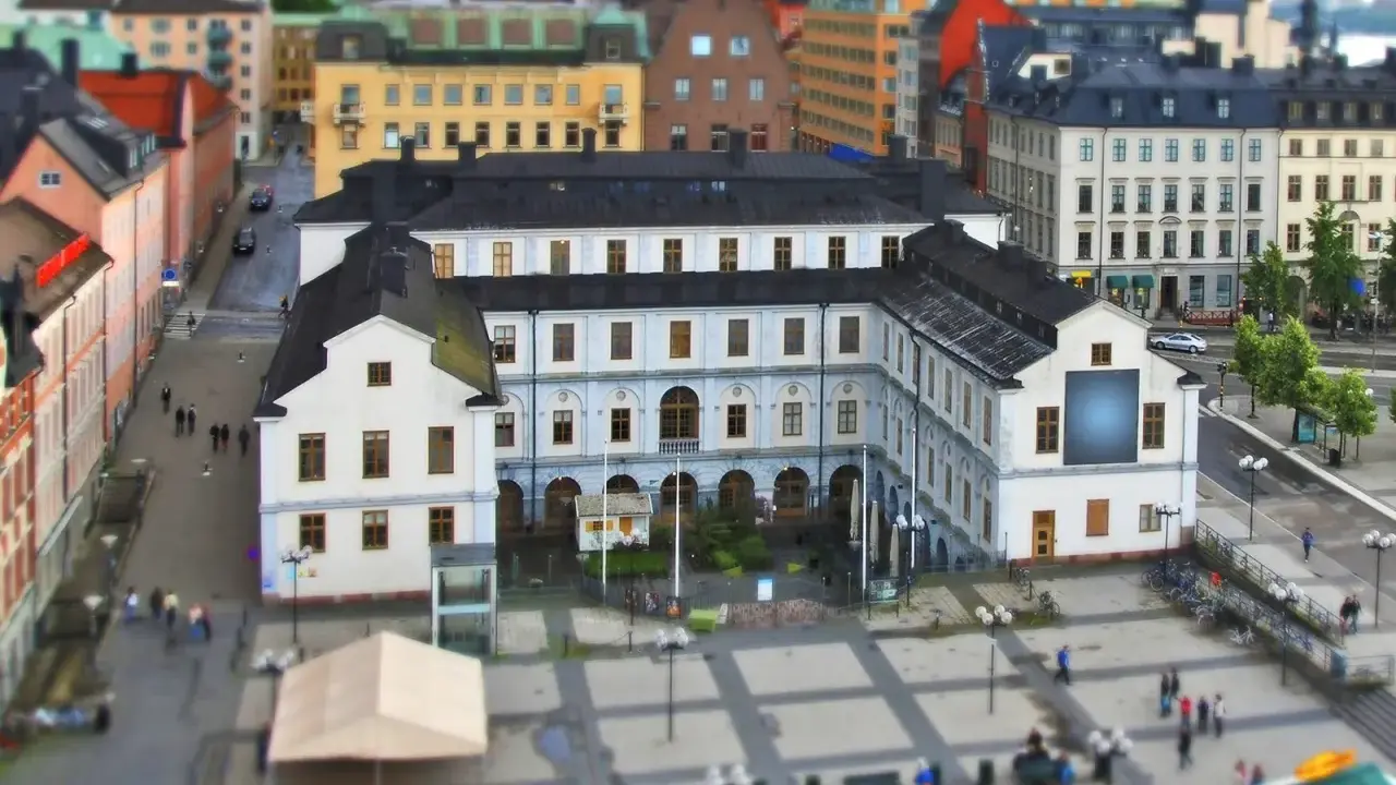 En vy över stadsmuseet i Stockholm med omgivande byggnader och en öppen plats med människor.
