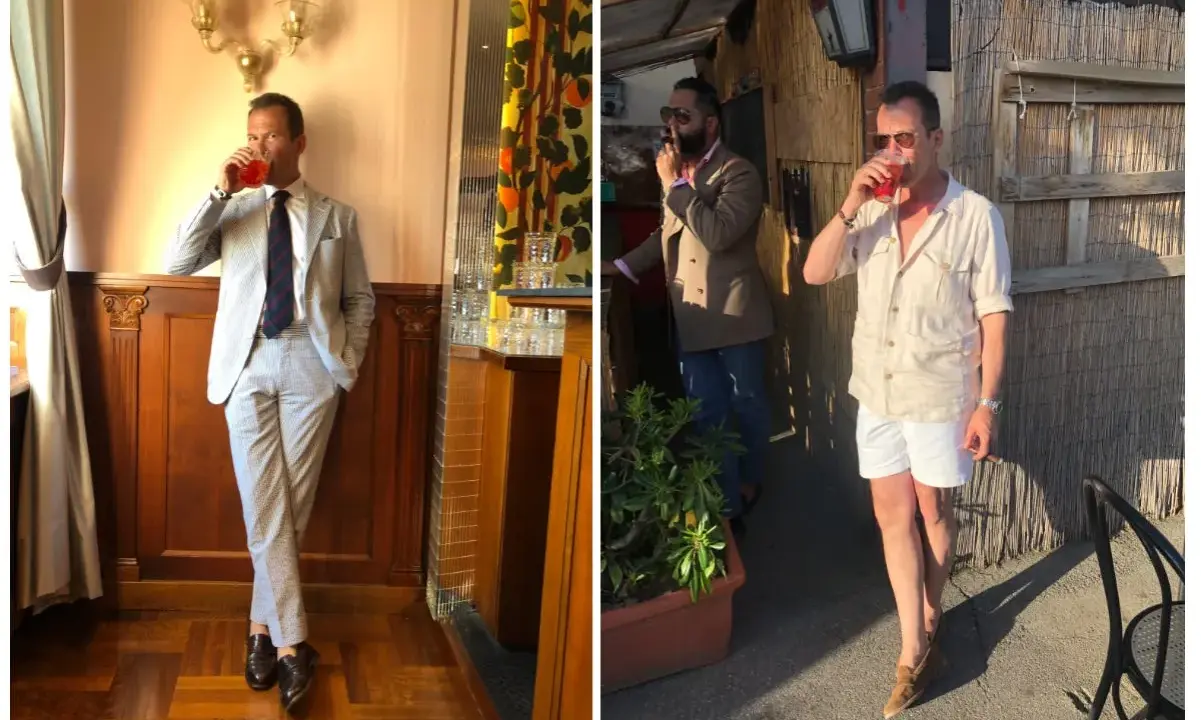 A man in a light-colored Havana suit sips a drink. Another man smokes a cigar.