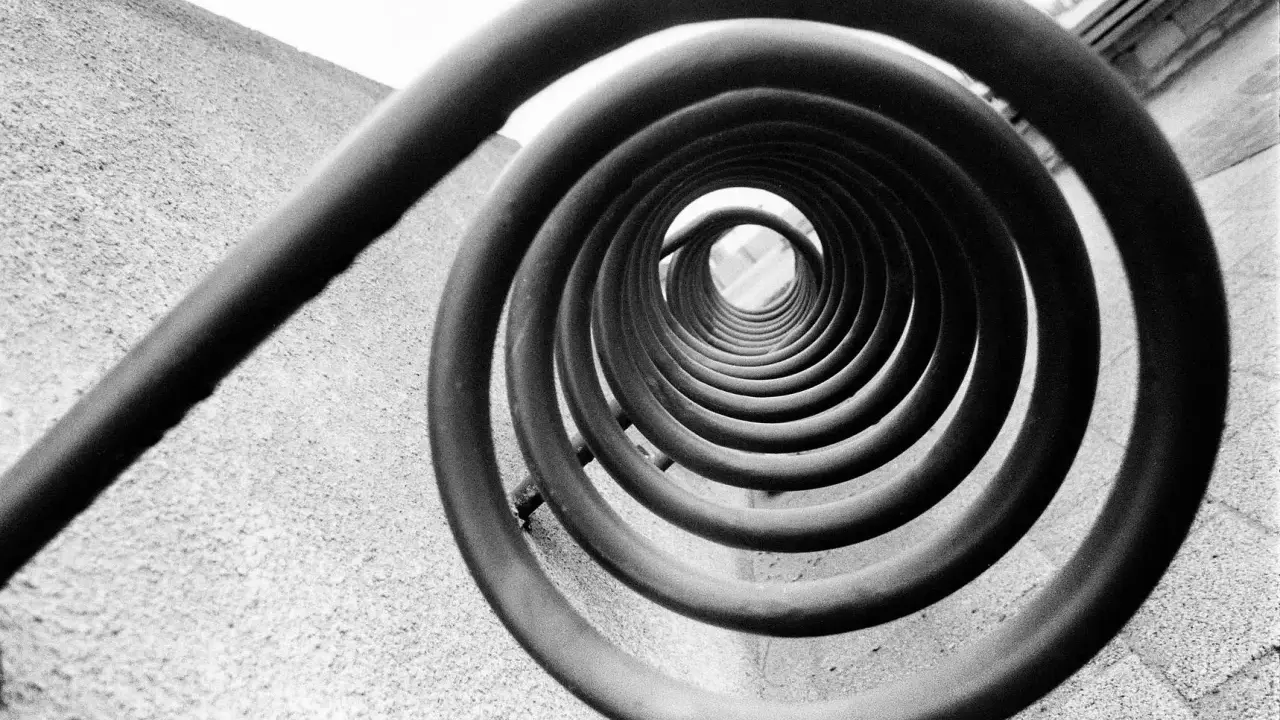 A spiral staircase, reminiscent of Edward Weston's famous photos, draws the eye inward.